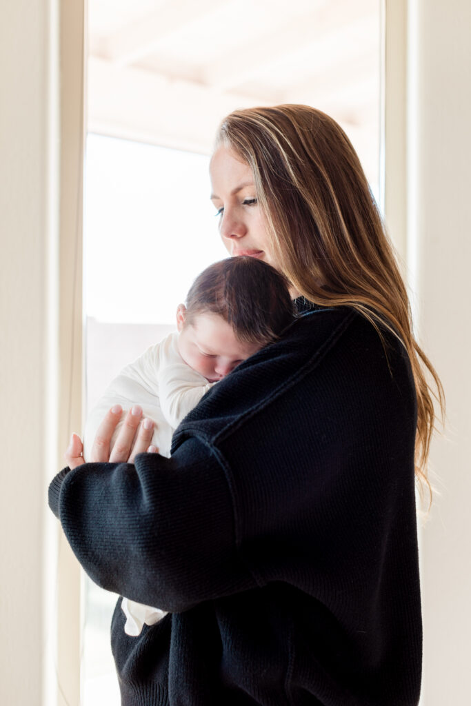 Monterey Motherhood Photographer newborn photographer. Mother holding newborn baby.